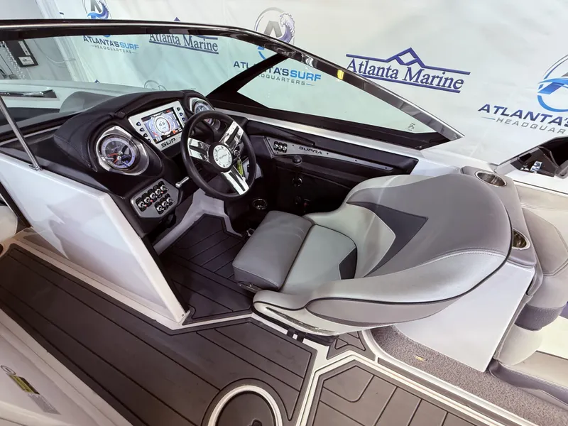 Slide: The Image of Interior of a 2014 Supra SC350 boat with steering console. - 19