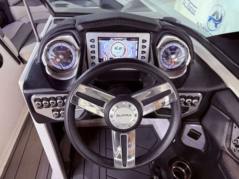 Slide: The Image of Dashboard of a 2014 Supra SC350 with steering wheel and gauges. - 26
