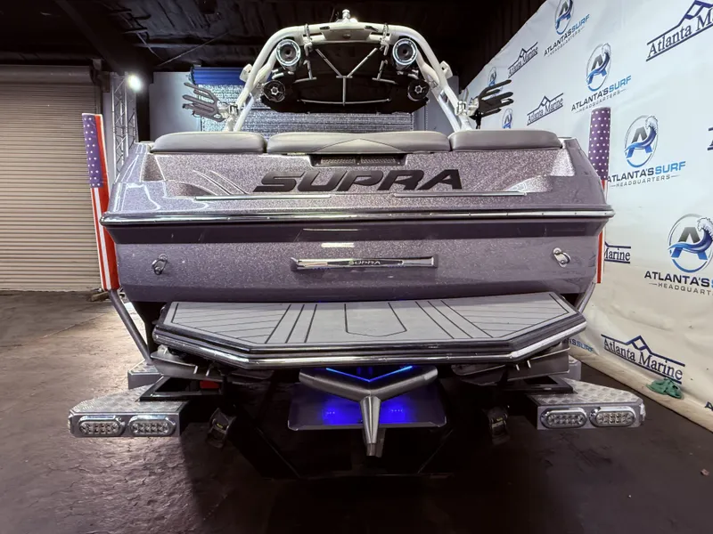 Slide: The Image of Rear view of a 2014 Supra SC350 boat in a showroom. - 4