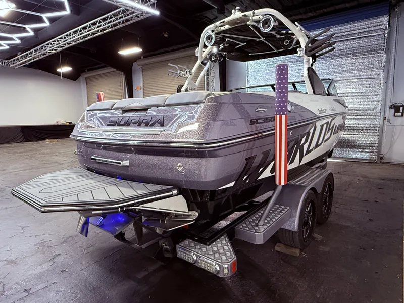 Slide: The Image of 2014 Supra SC350 boat in a garage, rear view. - 5