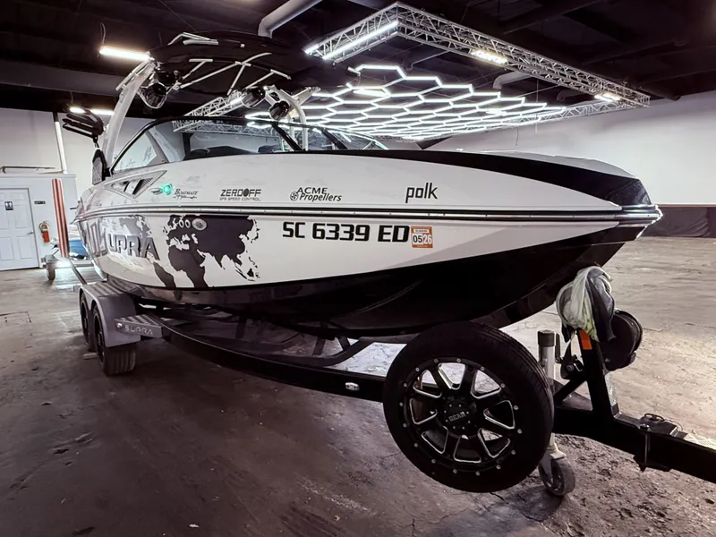 Slide: The Image of 2014 Supra SC350 boat indoors on a trailer. - 6
