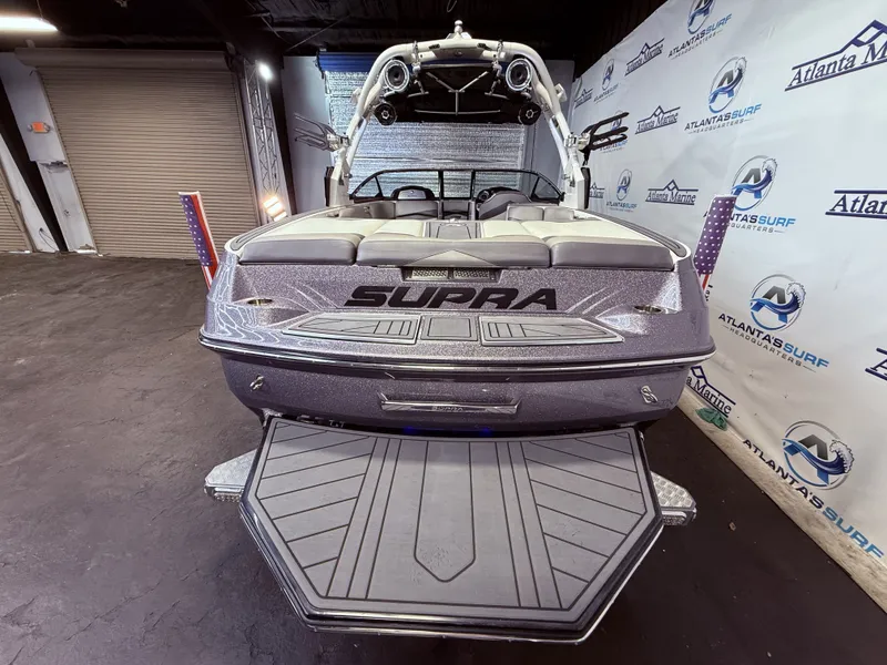 Slide: The Image of 2014 Supra SC350 boat in showroom with Atlanta Marine branding. - 8