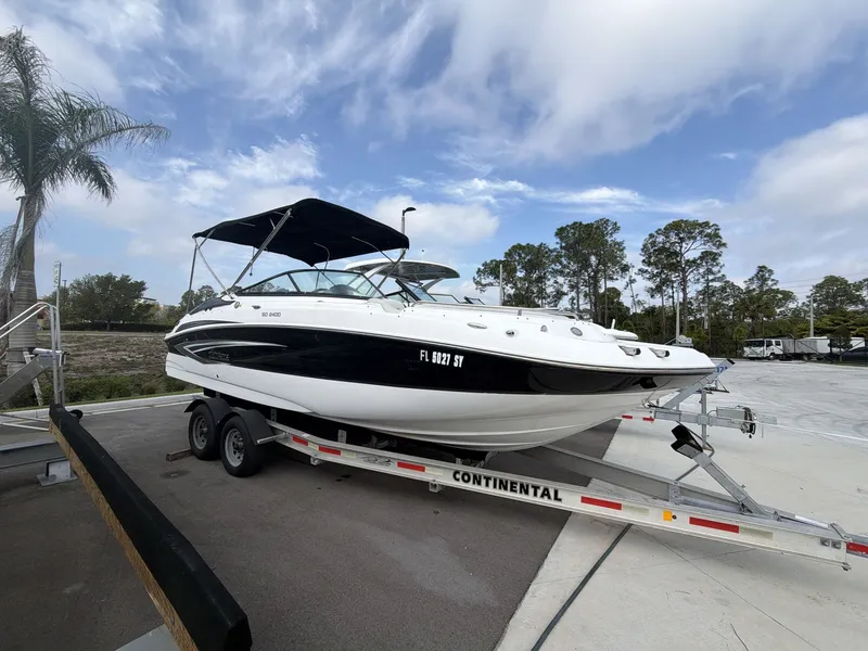 The Image of 2020 Hurricane 2400 SD boat on trailer under blue sky. - 1