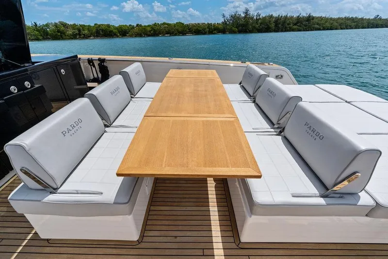 Slide: The Image of Luxury seating area on 2021 Pardo 43 yacht with wooden table and cushioned benches. - 12