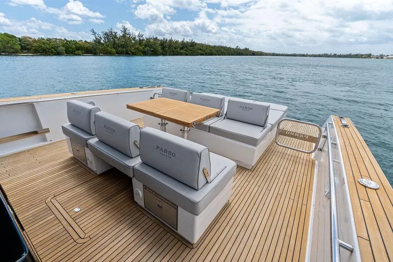 Slide: The Image of Luxury Pardo 43 yacht deck with seating and table, 2021 model, on calm water. - 16