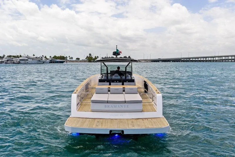 Slide: The Image of Luxury Pardo 43 yacht cruising on open water, 2021 model, with scenic marina backdrop. - 2