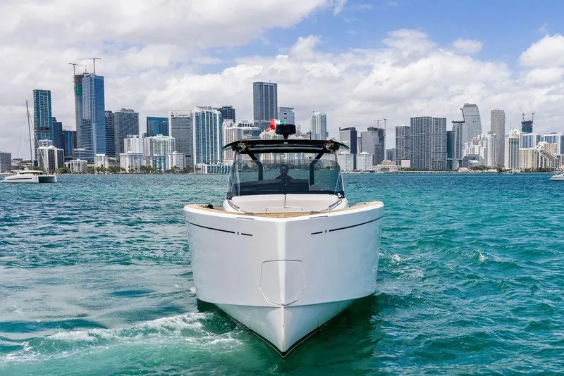 Slide: The Image of Pardo 43 yacht cruising in turquoise waters with city skyline backdrop, 2021 model. - 3