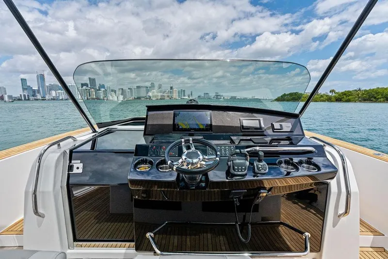 Slide: The Image of Cockpit view of 2021 Pardo 43 yacht with city skyline in background. - 9