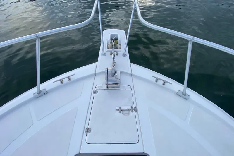 Slide: The Image of Bow of 1994 Luhrs 32 Convertible boat with anchor and railing. - 17