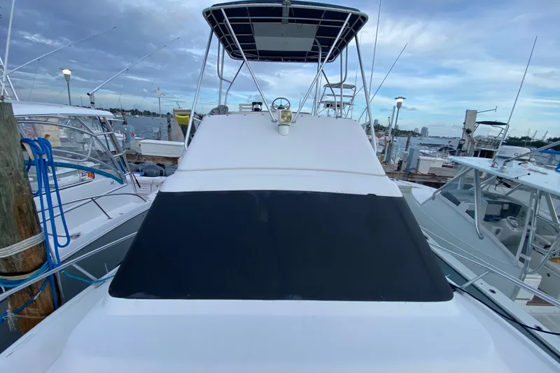 Slide: The Image of 1994 Luhrs 32 Convertible boat docked at marina, view of upper deck and helm. - 18