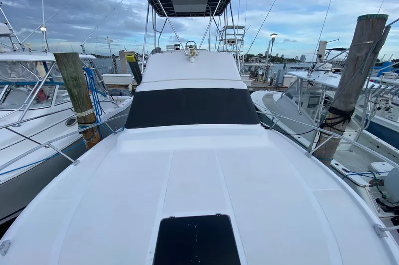 Slide: The Image of 1994 Luhrs 32 Convertible boat docked at marina, view from bow. - 19