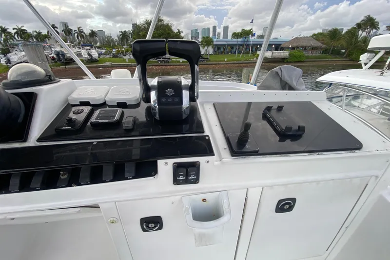 Slide: The Image of 1994 Luhrs 32 Convertible boat control panel with throttle and navigation equipment. - 24