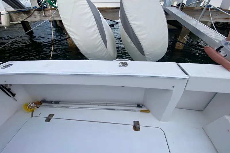 Slide: The Image of 1994 Luhrs 32 Convertible boat deck with cleaning tools and dock view. - 26