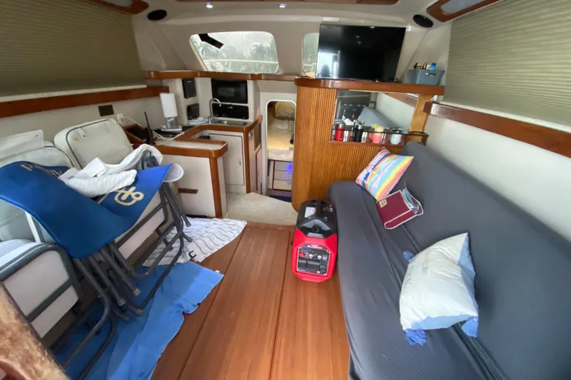 Slide: The Image of Interior of a 1994 Luhrs 32 Convertible boat with seating and kitchenette. - 27