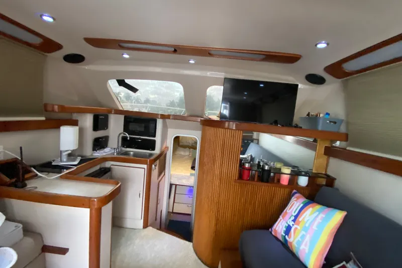 Slide: The Image of Interior of a 1994 Luhrs 32 Convertible boat with kitchen and seating area. - 30