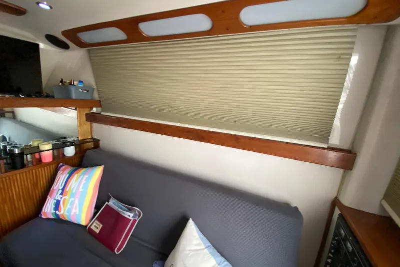 Slide: The Image of Interior of 1994 Luhrs 32 Convertible boat with cozy seating and colorful decor. - 31