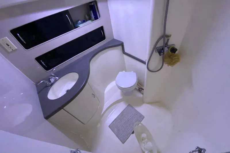 Slide: The Image of Bathroom interior of 1994 Luhrs 32 Convertible boat with sink, toilet, and shower. - 33