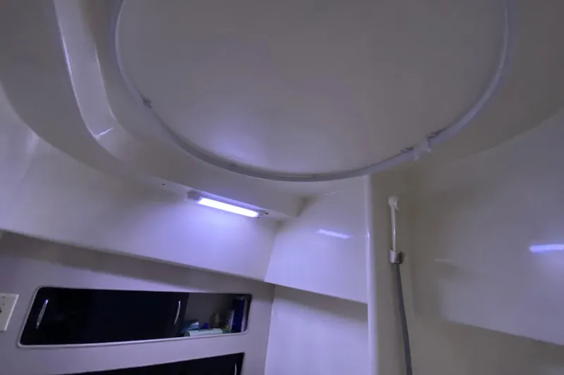 Slide: The Image of Interior of 1994 Luhrs 32 Convertible boat, featuring a ceiling hatch and lighting. - 35