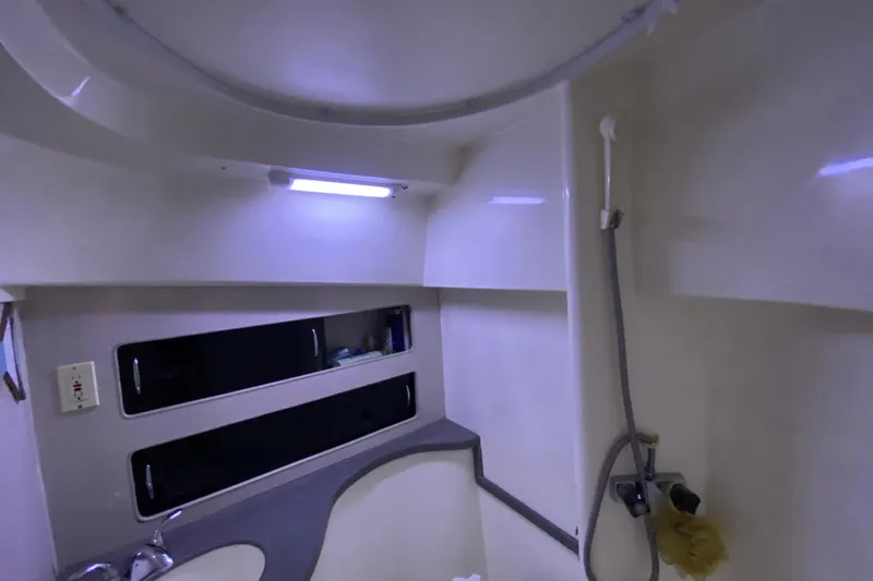 Slide: The Image of Interior of 1994 Luhrs 32 Convertible boat bathroom with shower and sink. - 36