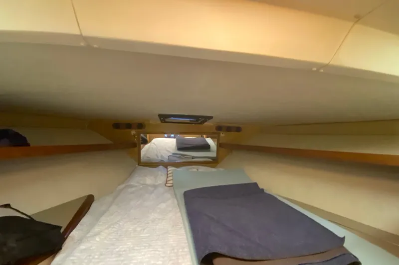 Slide: The Image of Interior cabin of 1994 Luhrs 32 Convertible boat with bedding and storage shelves. - 40
