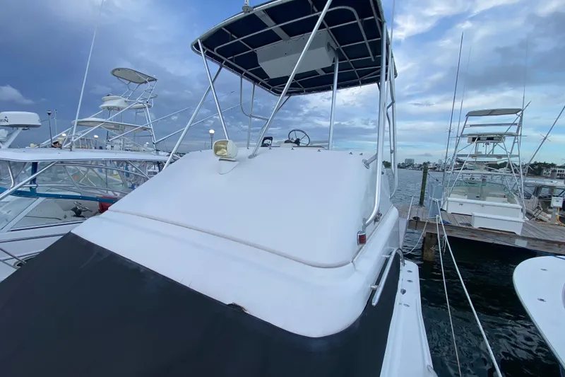 Slide: The Image of 1994 Luhrs 32 Convertible boat docked at marina under cloudy sky. - 41