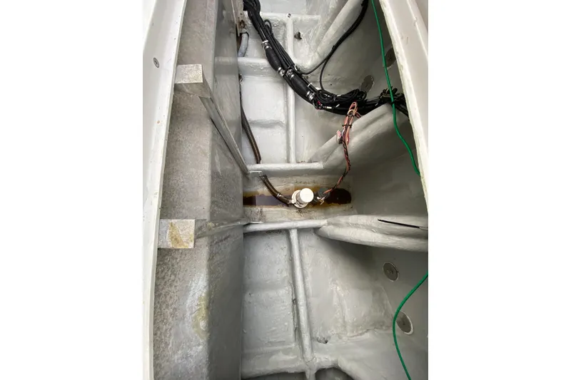 Slide: The Image of 1994 Luhrs 32 Convertible boat interior showing wiring and structural details. - 47