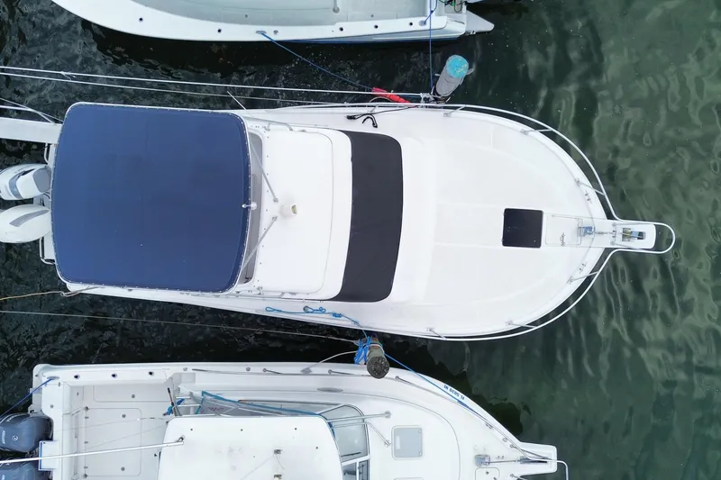 Slide: The Image of Aerial view of a 1994 Luhrs 32 Convertible boat docked in calm waters. - 52