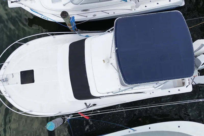 Slide: The Image of Aerial view of a 1994 Luhrs 32 Convertible boat docked at a marina. - 53