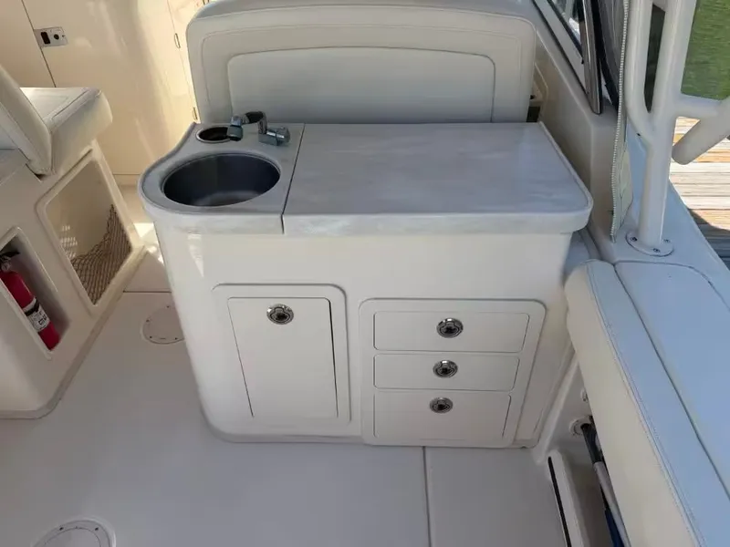 Slide: The Image of Interior of 2018 Grady-White Freedom 307 with sink and storage. - 11