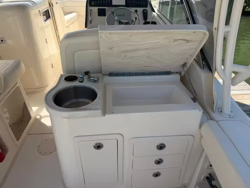 Slide: The Image of Interior of 2018 Grady-White Freedom 307 with sink and storage. - 13