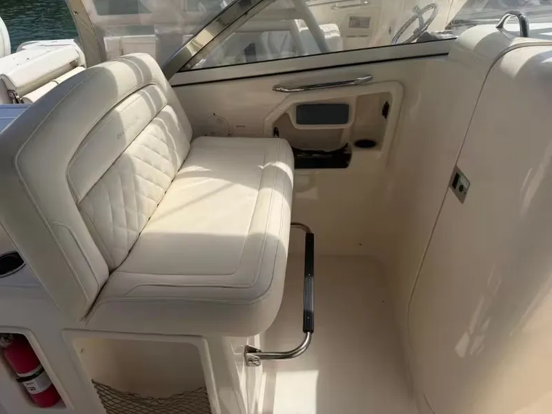 Slide: The Image of Interior of a 2018 Grady-White Freedom 307 boat with beige seating. - 14