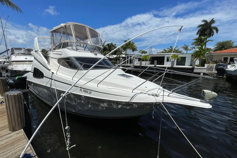 Slide: The Image of 2002 Silverton 330 Sport Bridge yacht docked in a sunny marina. - 13