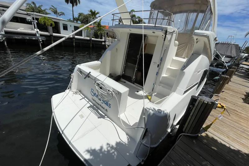 Slide: The Image of 2002 Silverton 330 Sport Bridge yacht docked at marina, rear view. - 18