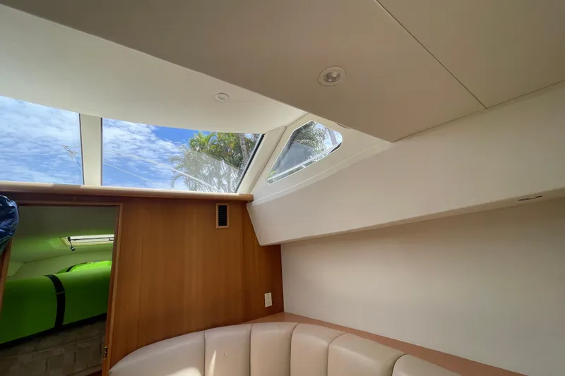 Slide: The Image of Interior view of 2002 Silverton 330 Sport Bridge with skylight and seating area. - 32