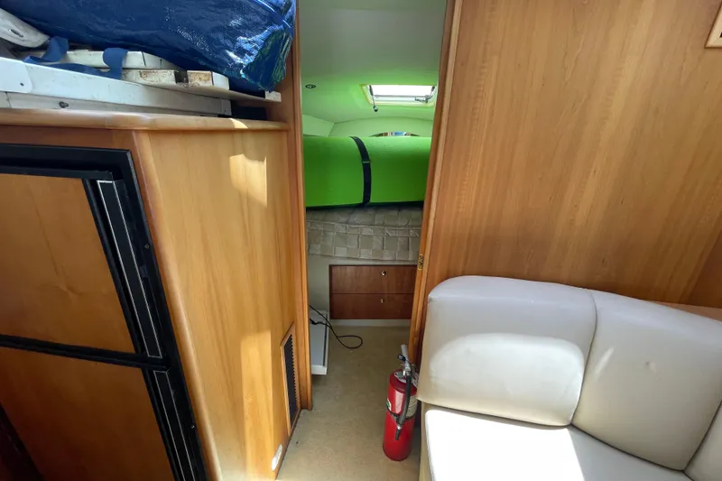 Slide: The Image of Interior of 2002 Silverton 330 Sport Bridge with cozy cabin and fire extinguisher. - 37