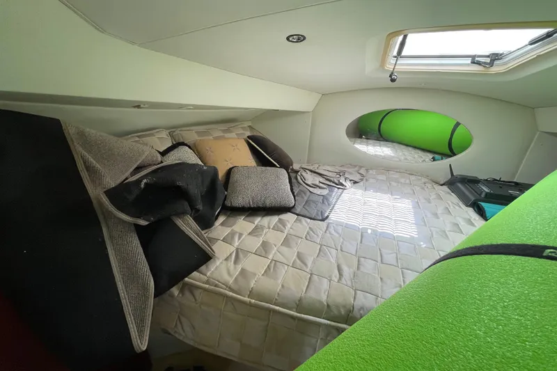Slide: The Image of Interior cabin of a 2002 Silverton 330 Sport Bridge with bed and cushions. - 38