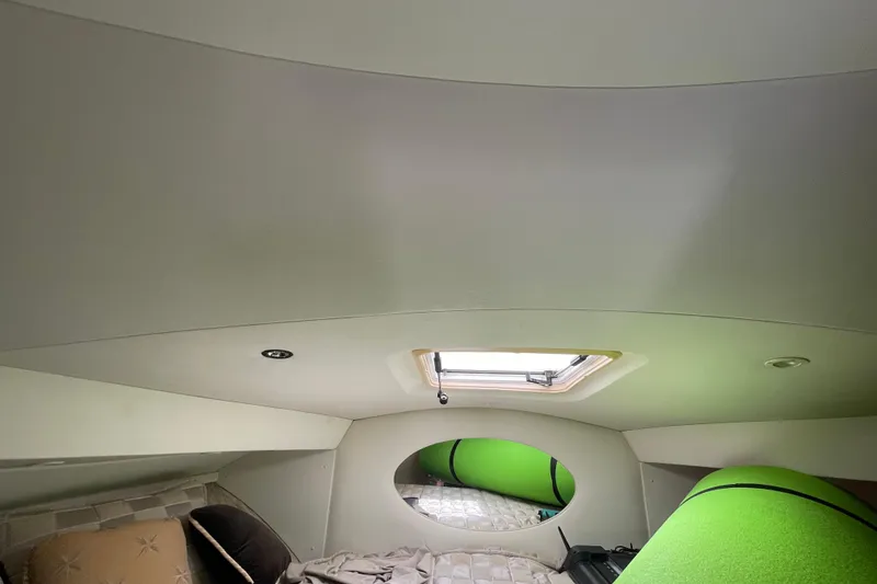 Slide: The Image of Interior cabin of 2002 Silverton 330 Sport Bridge with bedding and porthole. - 39