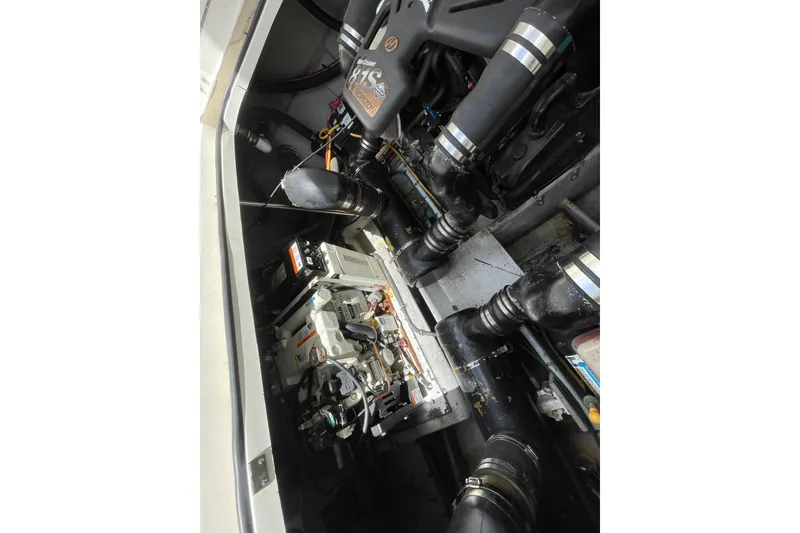 Slide: The Image of Engine compartment of a 2002 Silverton 330 Sport Bridge boat, showcasing mechanical components. - 46