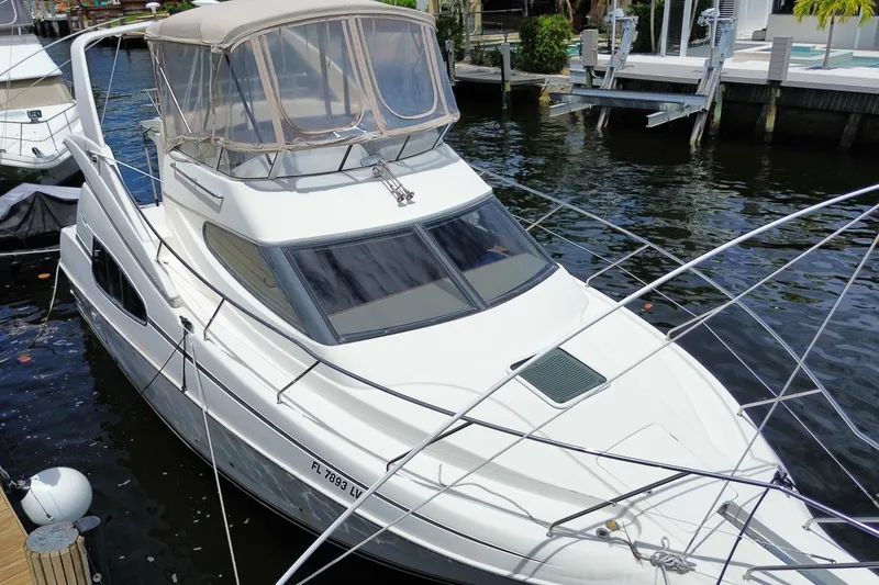 Slide: The Image of 2002 Silverton 330 Sport Bridge yacht docked in a marina. - 47