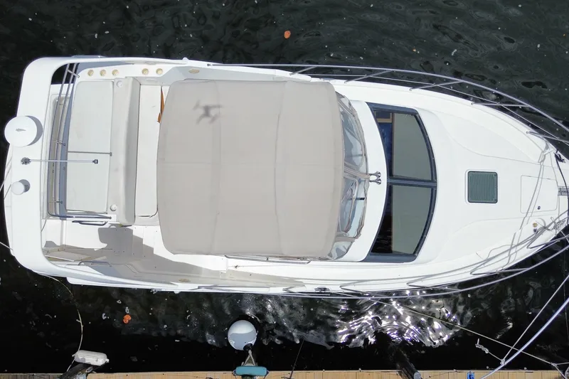 Slide: The Image of Overhead view of a 2002 Silverton 330 Sport Bridge yacht docked on water. - 51