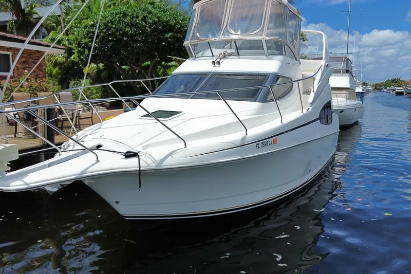 Slide: The Image of 2002 Silverton 330 Sport Bridge yacht docked on a sunny day. - 65