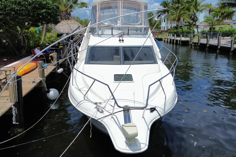 Slide: The Image of 2002 Silverton 330 Sport Bridge docked by tropical waterfront. - 66