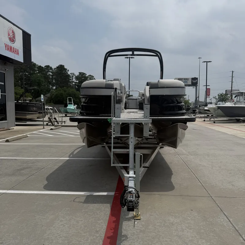 Slide: The Image of 2026 Avalon QLS25T Excalibur boat on trailer outside Yamaha store. - 5