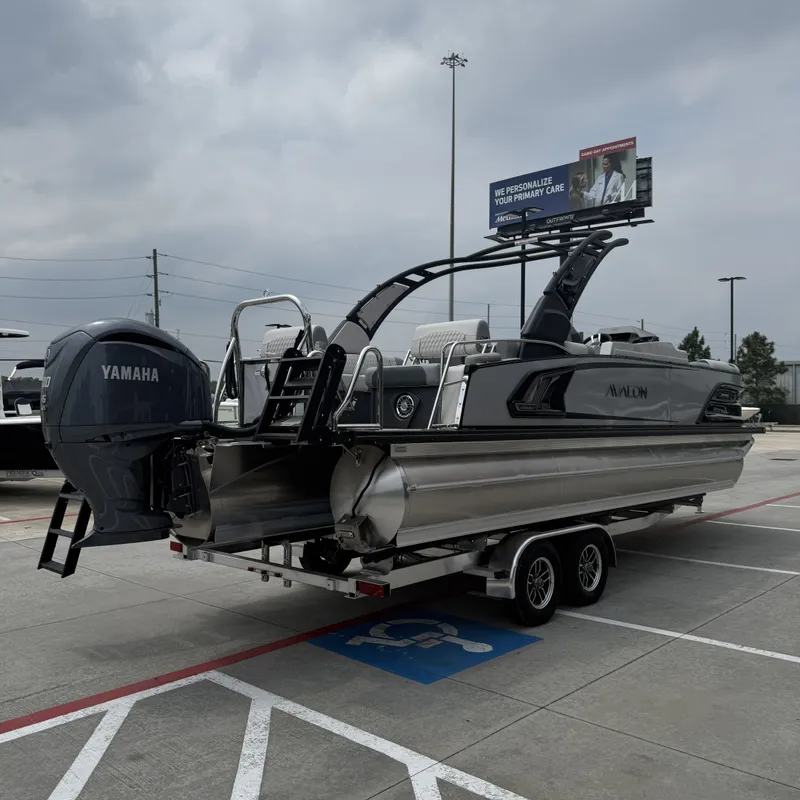 Slide: The Image of 2026 Avalon QLS25T Excalibur pontoon boat with Yamaha engine on trailer. - 8