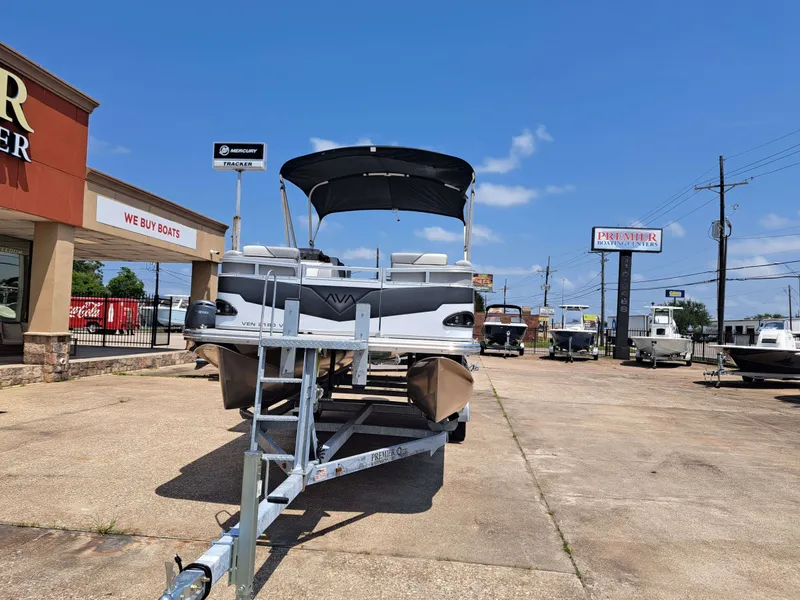 Slide: The Image of Avalon VNT VRB21 2026 pontoon boat on trailer at boat dealership. - 9