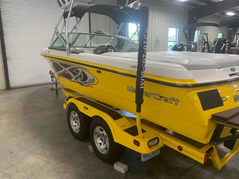 Slide: The Image of Yellow 2003 MasterCraft X2 boat in a warehouse. - 3