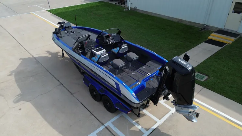 Slide: The Image of 2025 Vexus DVX22S boat on trailer, blue and black, exterior view. - 13