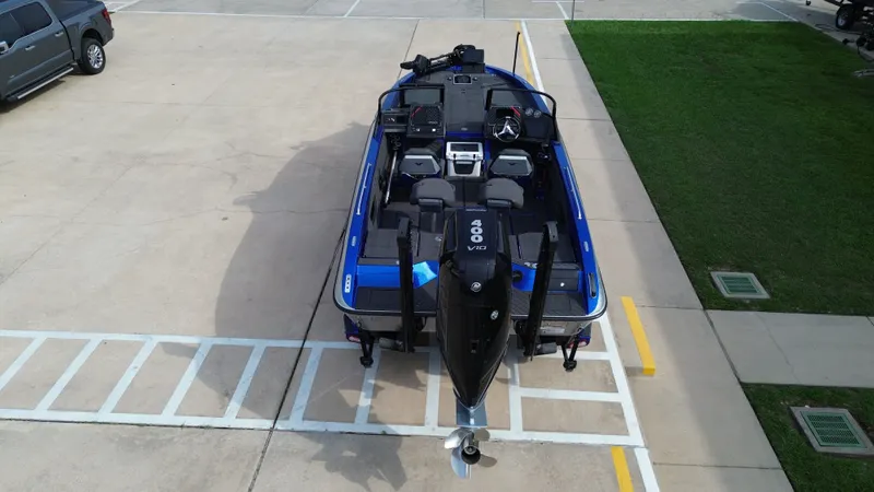 Slide: The Image of Aerial view of a blue 2025 Vexus DVX22S boat on a parking lot. - 14