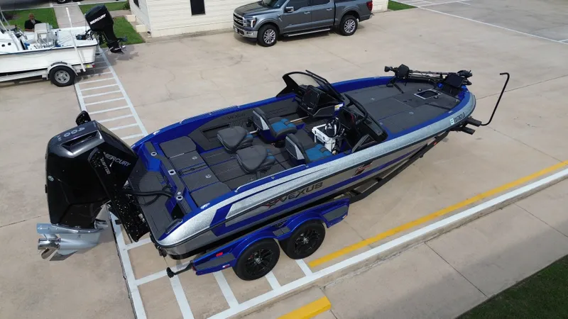 Slide: The Image of 2025 Vexus DVX22S boat on trailer, blue and silver. - 15