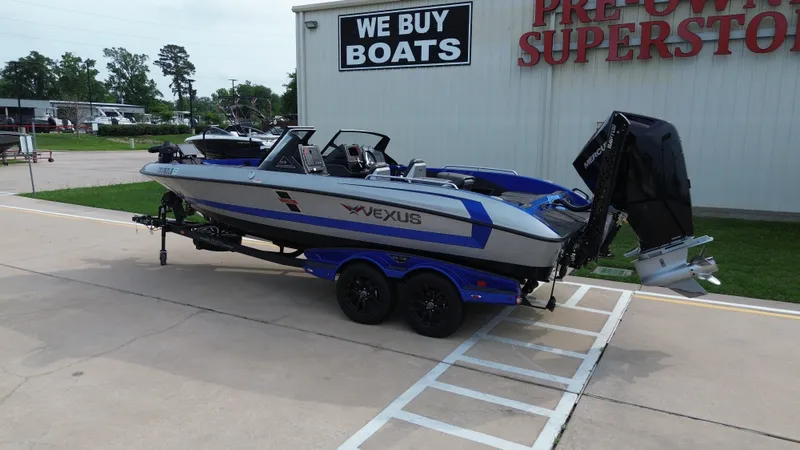 Slide: The Image of 2025 Vexus DVX22S boat on trailer outside boat dealership. - 3